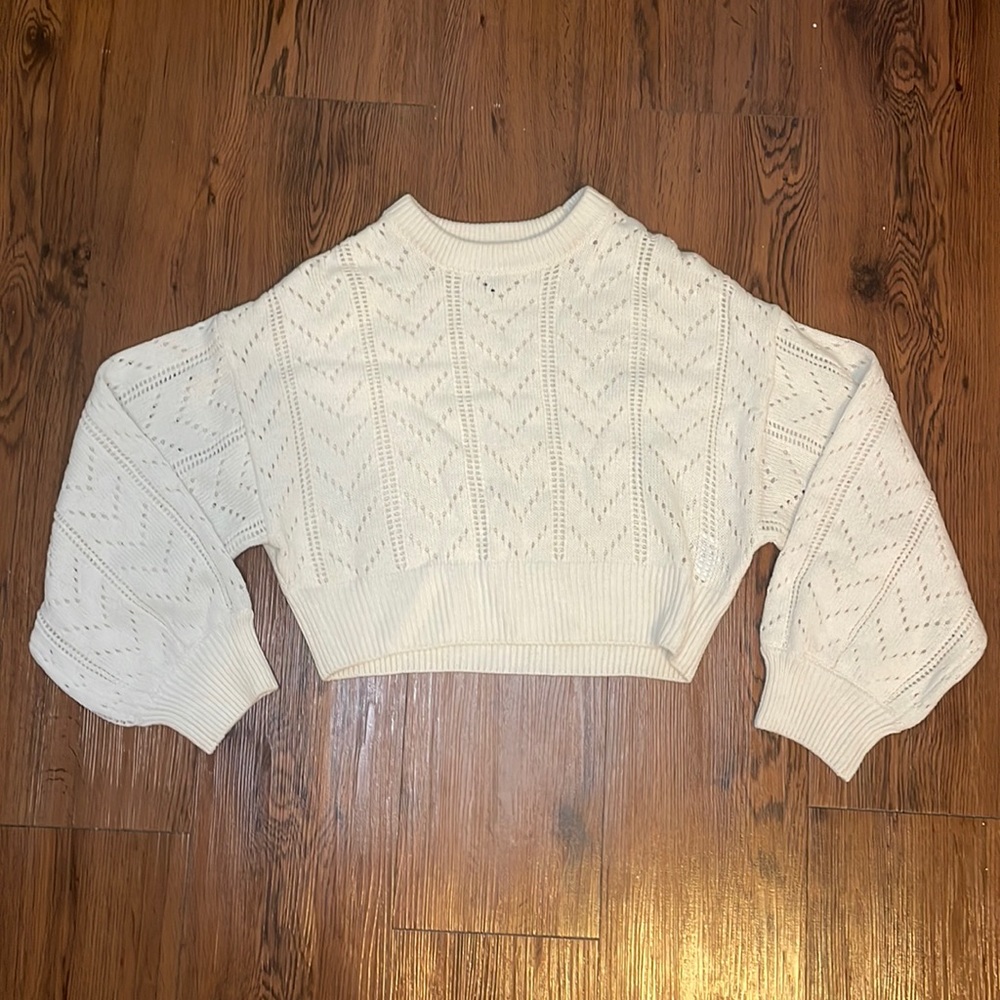 Cream sweater, open knit in front, solid back. Size extra small